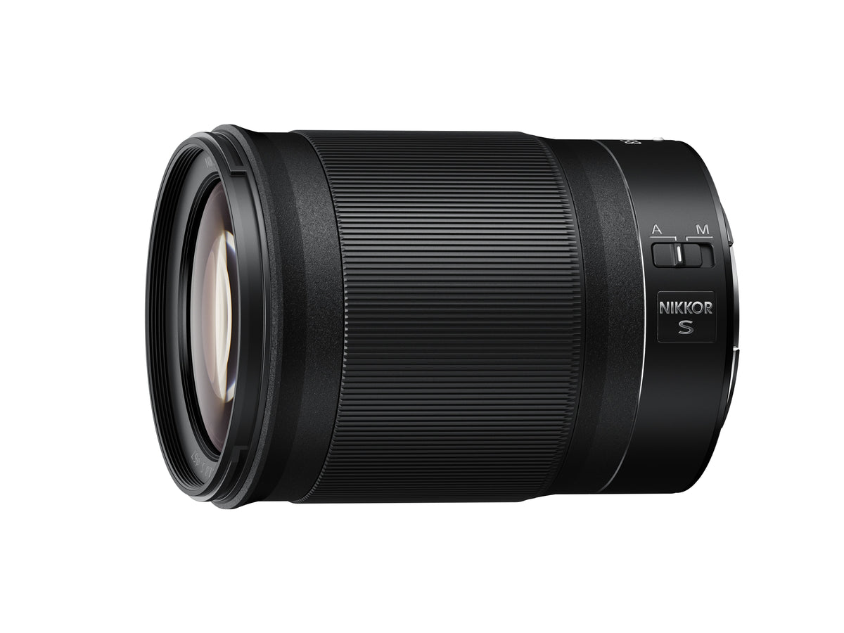 Nikon Z 85mm f/1.8 S lens in black, shown at a three-quarter angle on a solid white background.
